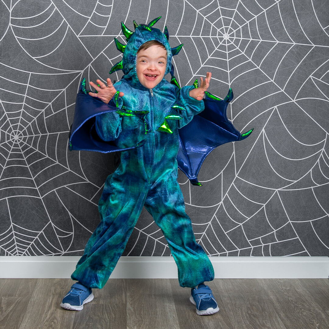 Boy in a dragon costume for Halloween photos.