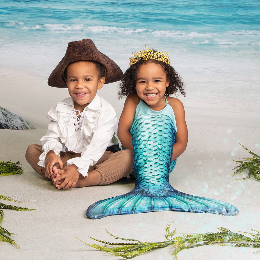 Brother and sister in pirate and mermaid costumes
