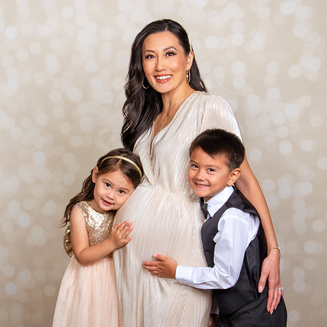 Woman and two children posing for maternity pictures
