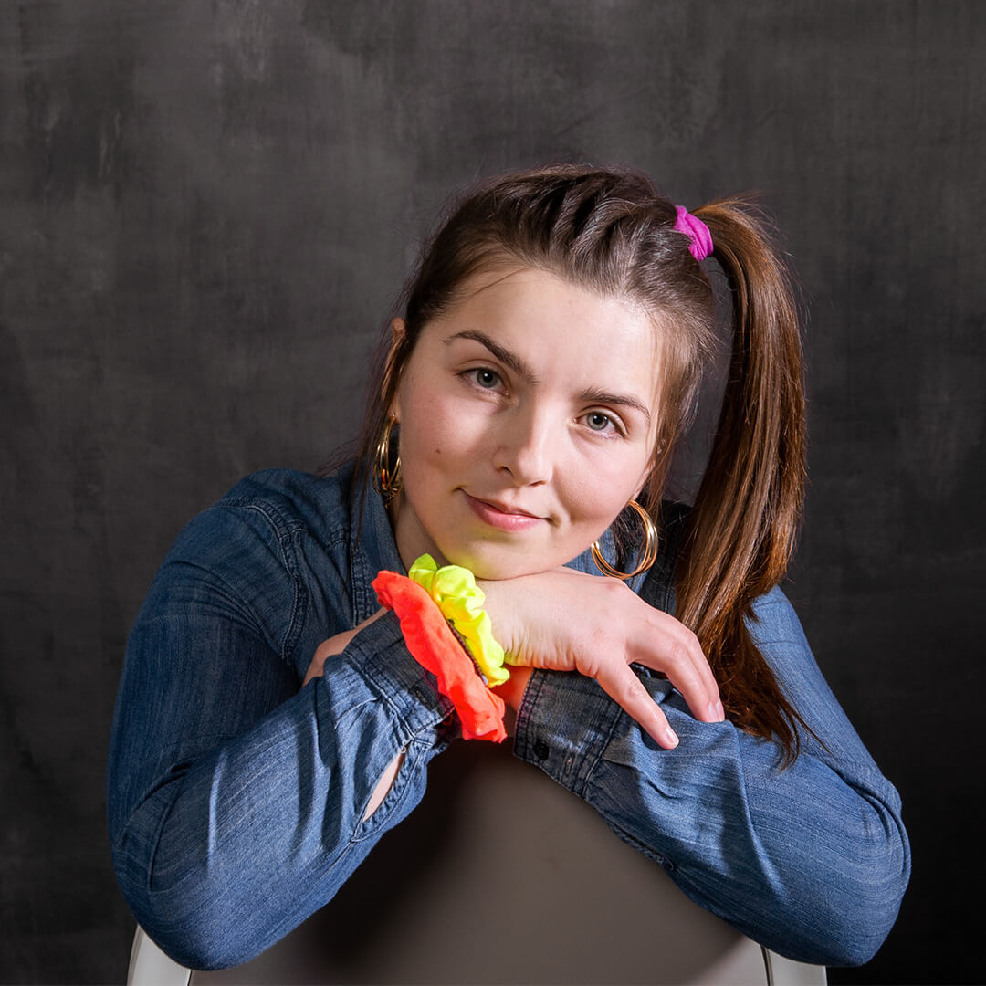 Woman in a side ponytail and scrunchies posing for retro pictures