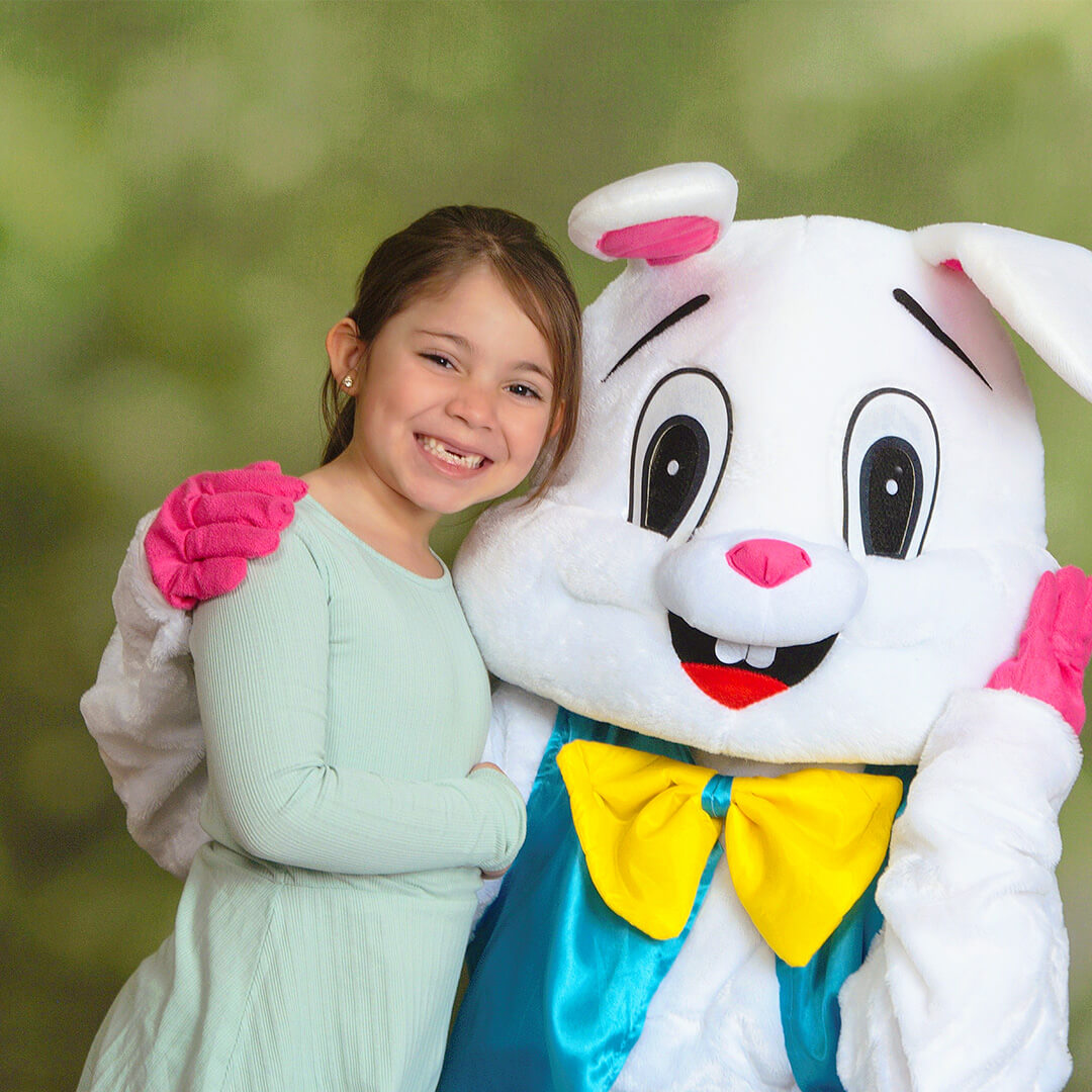Easter photo of young girl posing with Easter Bunny.