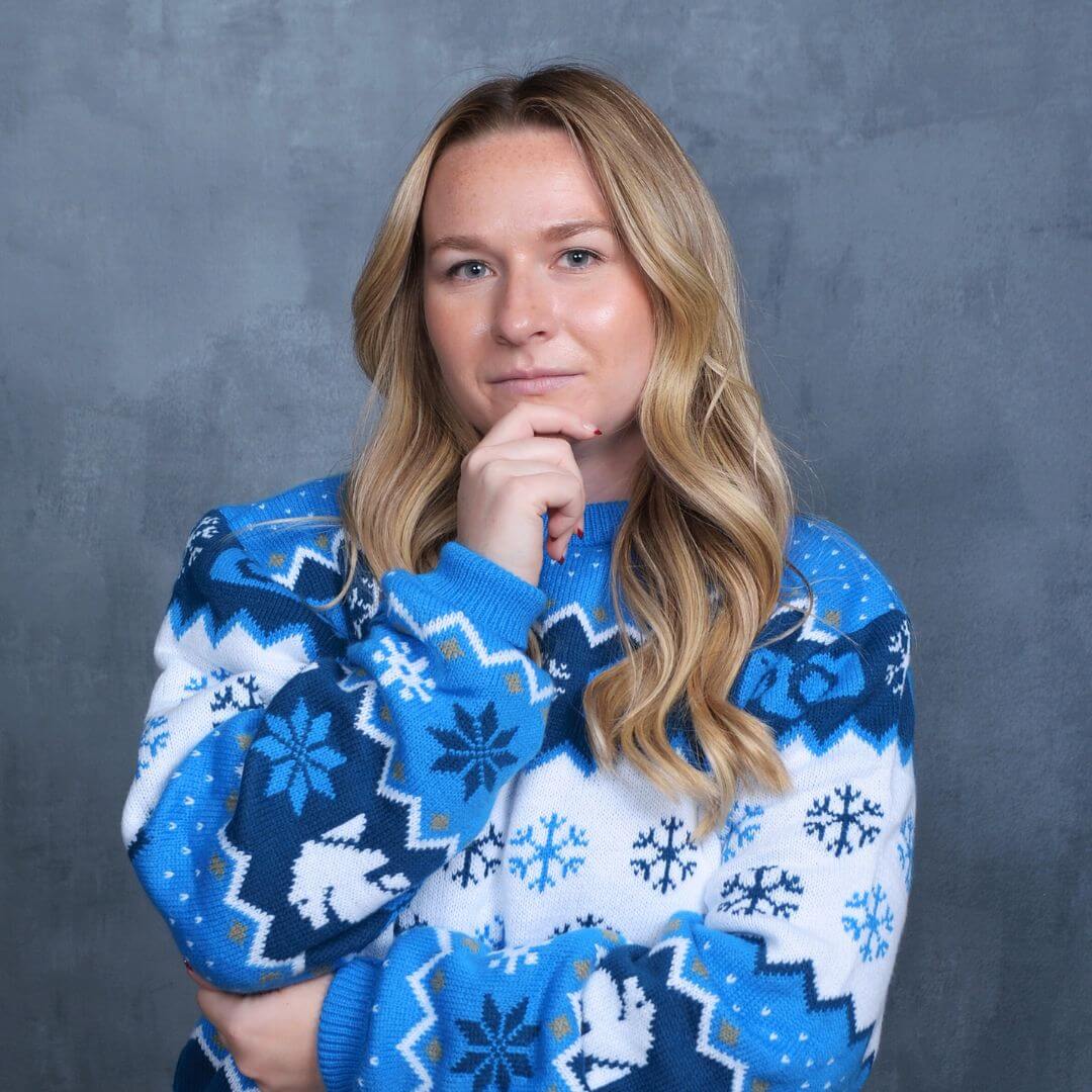 Woman in holiday sweater for awkward holiday pictures