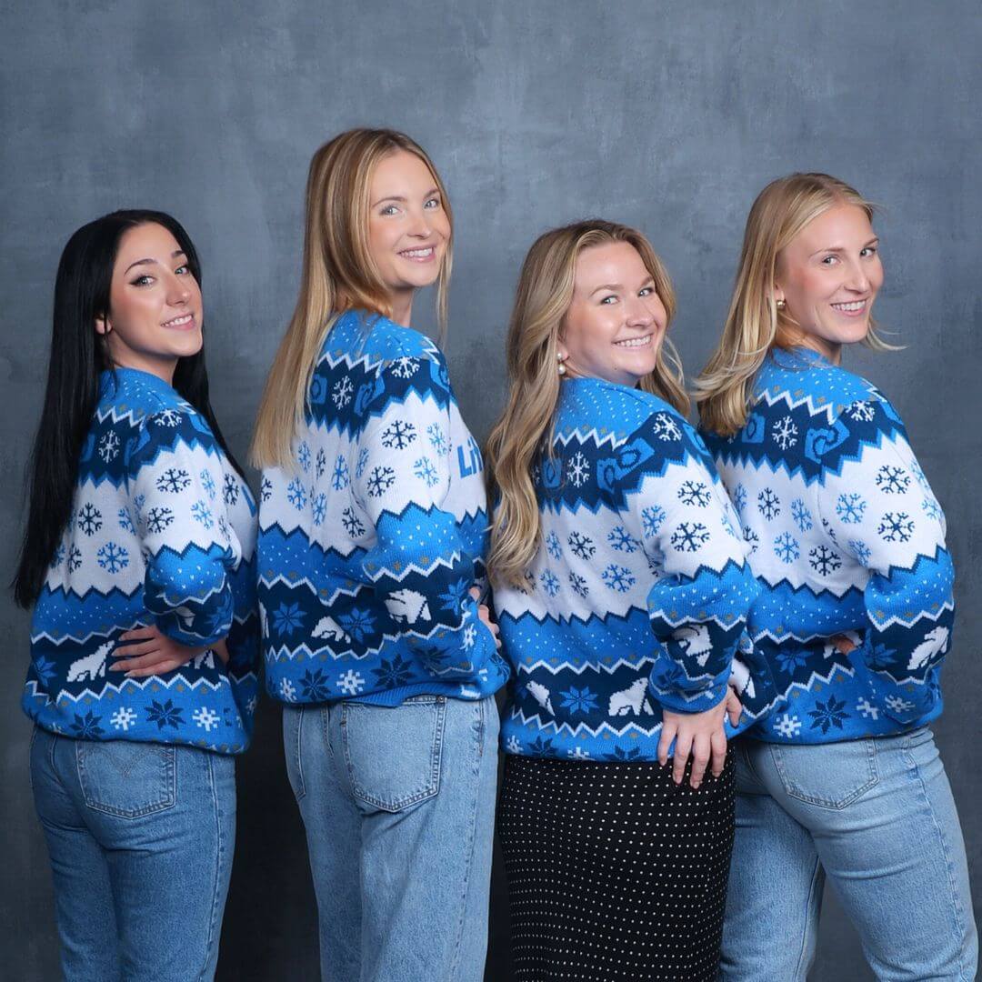 Women with hands on their hips posing for festive holiday photography