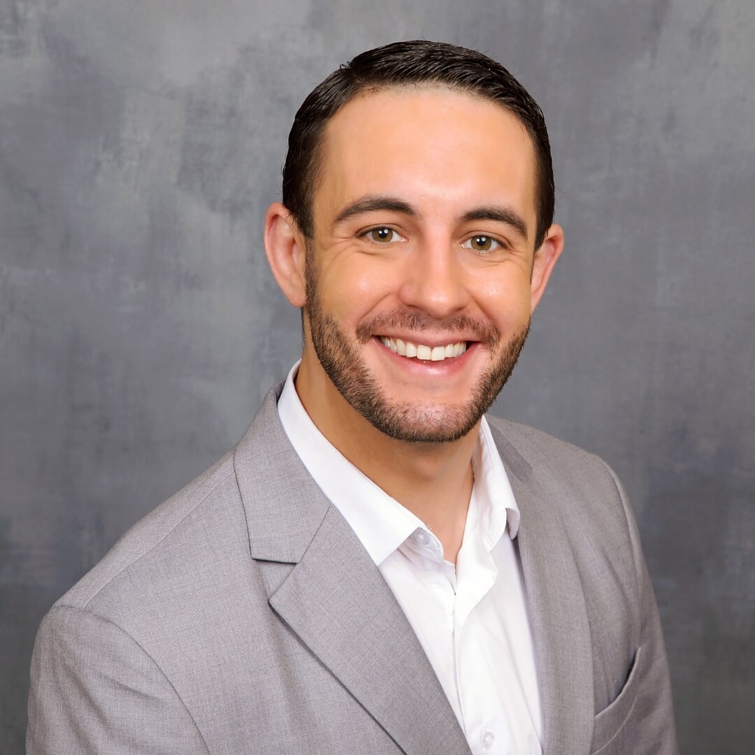 Man in a gray suit posing for business headshots