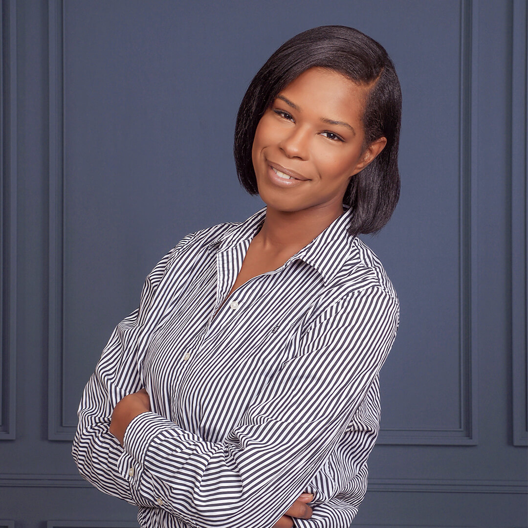 Woman wearing a striped shirt posing for business headshots.